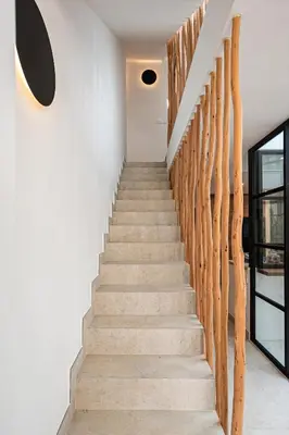 a staircase in a house with wooden railings at Casa junto al mar con piscina 45 in Conil de la Frontera