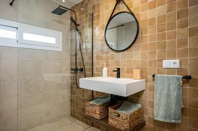 a bathroom with a sink and a mirror at Casa junto al mar con piscina 45 in Conil de la Frontera