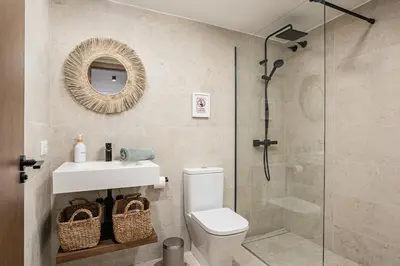 a bathroom with a shower and a toilet and a sink at Casa junto al mar con piscina 45 in Conil de la Frontera