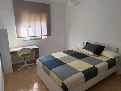 a bedroom with a bed and a desk and a chair at Apartment Las Mareas in Puerto Real