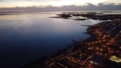 an aerial view of a city and the ocean at night at Apartment Las Mareas in Puerto Real