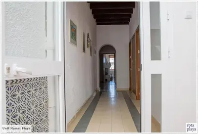 a hallway with white walls and a tile floor at Family Friendly 2BDR Unit in Rota - Playa in Rota