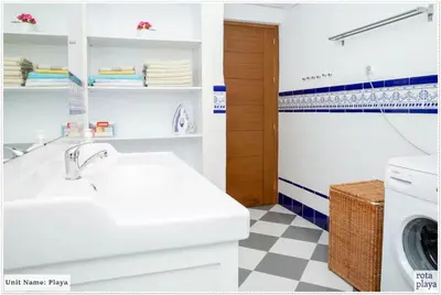 a kitchen with a sink and a washing machine at Family Friendly 2BDR Unit in Rota - Playa in Rota