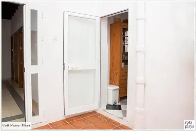 a large mirror in a room with a bathroom at Family Friendly 2BDR Unit in Rota - Playa in Rota