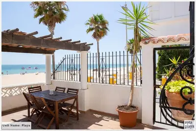 a patio with a table and a view of the beach at Family Friendly 2BDR Unit in Rota - Playa in Rota