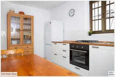 a kitchen with a refrigerator and a stove top oven at Family Friendly 2BDR Unit in Rota - Playa in Rota