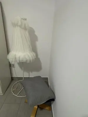 a corner of a room with a bed and a lamp at Austria 03 in Lebrija