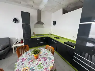 a kitchen with a table with a pot on it at Austria 03 in Lebrija