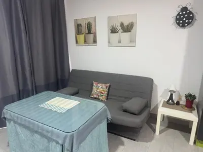 a living room with a couch and a table at Austria 03 in Lebrija