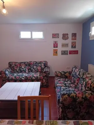 a living room with two couches and a table at Villa Playa La Barrosa in Novo Sancti Petri