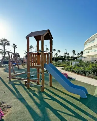 a playground with a slide at Penthouse duplex with jacuzzi, 5 min to beach in Chipiona