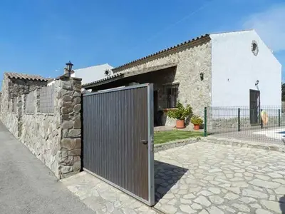 a stone building with a gate in front of it at Casas Elena-Conil in Conil de la Frontera