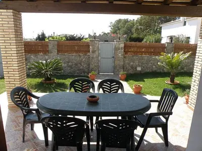 a black table and chairs on a patio at Casas Elena-Conil in Conil de la Frontera