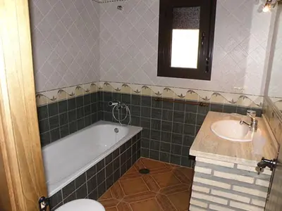 a bathroom with a tub and a sink and a toilet at Casas Elena-Conil in Conil de la Frontera