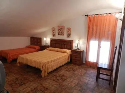 a bedroom with two beds and a window at Casas Elena-Conil in Conil de la Frontera