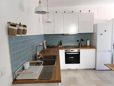 a kitchen with white cabinets and a sink at Ático recién reformado en el centro de Sanlúcar - LOVE SANLUCAR in Sanlúcar de Barrameda