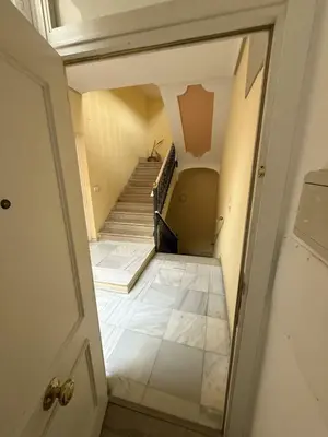 a view of a staircase from a hallway with a door at GATU Prioral in El Puerto de Santa María