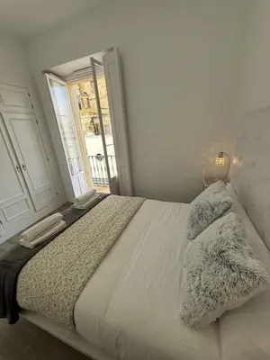 a bedroom with a bed with two pillows on it at GATU Prioral in El Puerto de Santa María