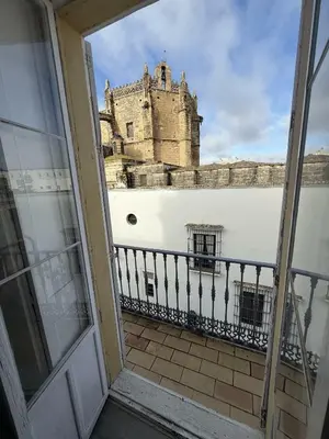 a view of a castle from the balcony of a building at GATU Prioral in El Puerto de Santa María