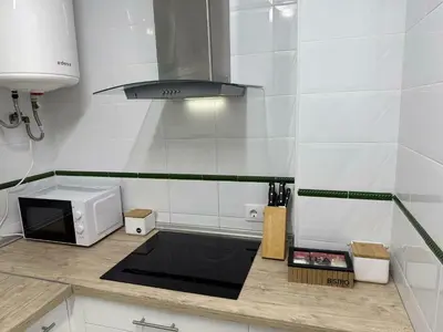 a kitchen with a counter top with a microwave at GATU Prioral in El Puerto de Santa María
