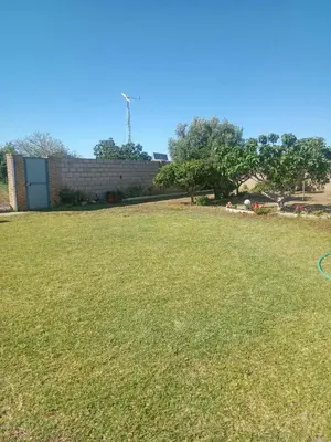 a large grassy yard with a building in the background at Valentina in Chiclana de la Frontera