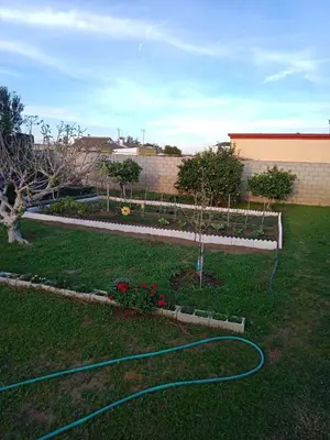 a garden with a hose in a yard at Valentina in Chiclana de la Frontera