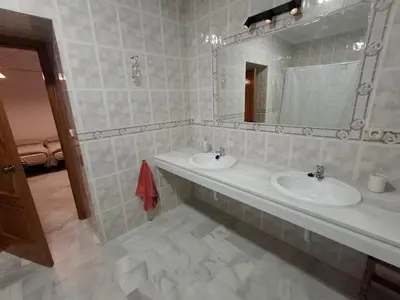 a bathroom with two sinks and a mirror at Hacienda La Caridad in El Puerto de Santa María