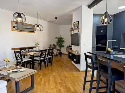a kitchen and dining room with tables and chairs at Apartamento Antique Muralla - Ole Solutions in Jerez de la Frontera