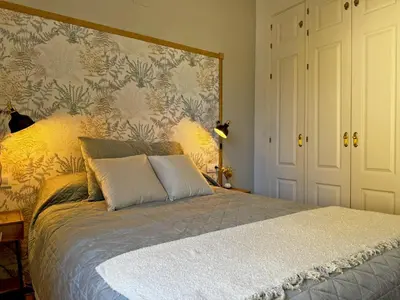 a bedroom with a window with a view of a castle at Apartamento Antique Muralla - Ole Solutions in Jerez de la Frontera