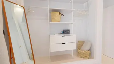 a white closet with a mirror and a dresser at Casa Chica 1 Sanlúcar de Barrameda. by Ruralidays in Sanlúcar de Barrameda