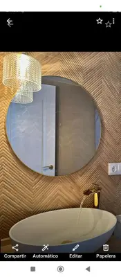 a bathroom with a round mirror and a bath tub at Hs Nieves Centro in Chipiona
