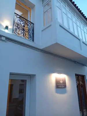 a white house with a light on the side of it at Hs Nieves Centro in Chipiona