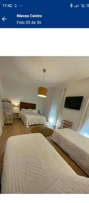 two beds in a room with two beds sidx sidx sidx at Hs Nieves Centro in Chipiona