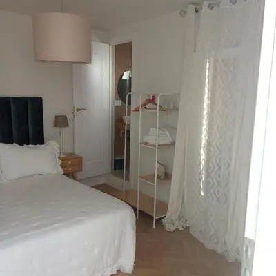 a bedroom with a white bed and a window at Hs Nieves Centro in Chipiona