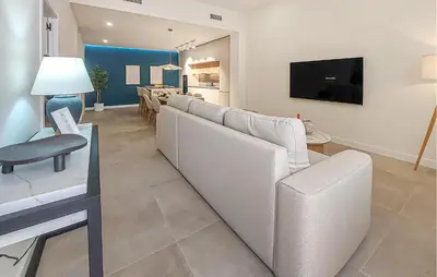 a living room with a white couch and a tv at 1 Bedroom Nice Apartment In Arcos De La Frontera in Arcos de la Frontera