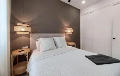 a bedroom with a white bed and two lamps at 1 Bedroom Nice Apartment In Arcos De La Frontera in Arcos de la Frontera