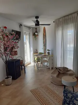 a living room with a table and a dining room at Balcón al Mar in Rota