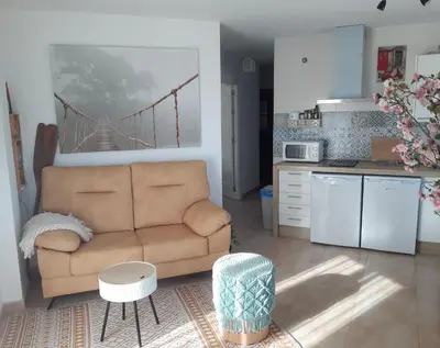 a living room with a couch and a kitchen at Balcón al Mar in Rota