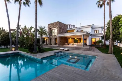 a house with a swimming pool in front of a house at A paradise with ocean views in Conil de la Frontera