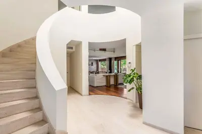 a white staircase in a home with a white stair case at A paradise with ocean views in Conil de la Frontera