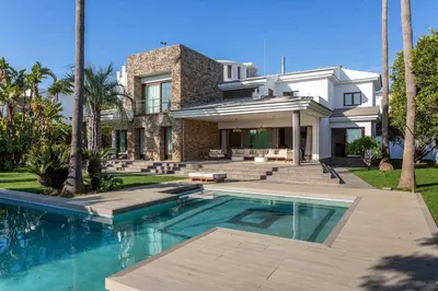 a house with a swimming pool in front of a house at A paradise with ocean views in Conil de la Frontera