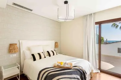 a bedroom with a bed with a tray of food on it at A paradise with ocean views in Conil de la Frontera