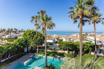 an aerial view of a resort with a swimming pool and palm trees at A paradise with ocean views in Conil de la Frontera