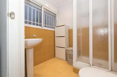 a bathroom with a sink and a shower and a toilet at Victoriamar in Cádiz