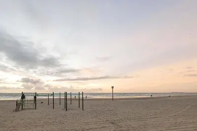 a beach with a group of poles in the sand at Victoriamar in Cádiz
