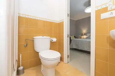a bathroom with a toilet in a room at Victoriamar in Cádiz