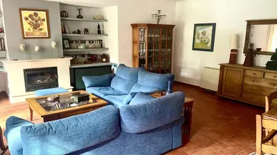 a living room with blue couches and a fireplace at Avenida de los Pescadores in Novo Sancti Petri