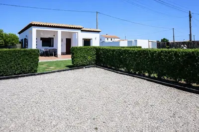 a house with a hedge in front of a house at Chalet Atardecer in Conil de la Frontera
