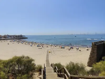 a beach with a bunch of people on the beach at Adelitas Home El Puerto in El Puerto de Santa María