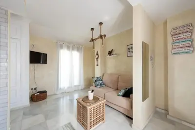 a living room with a couch and a fireplace at Atico Con Encanto Centro in Jerez de la Frontera